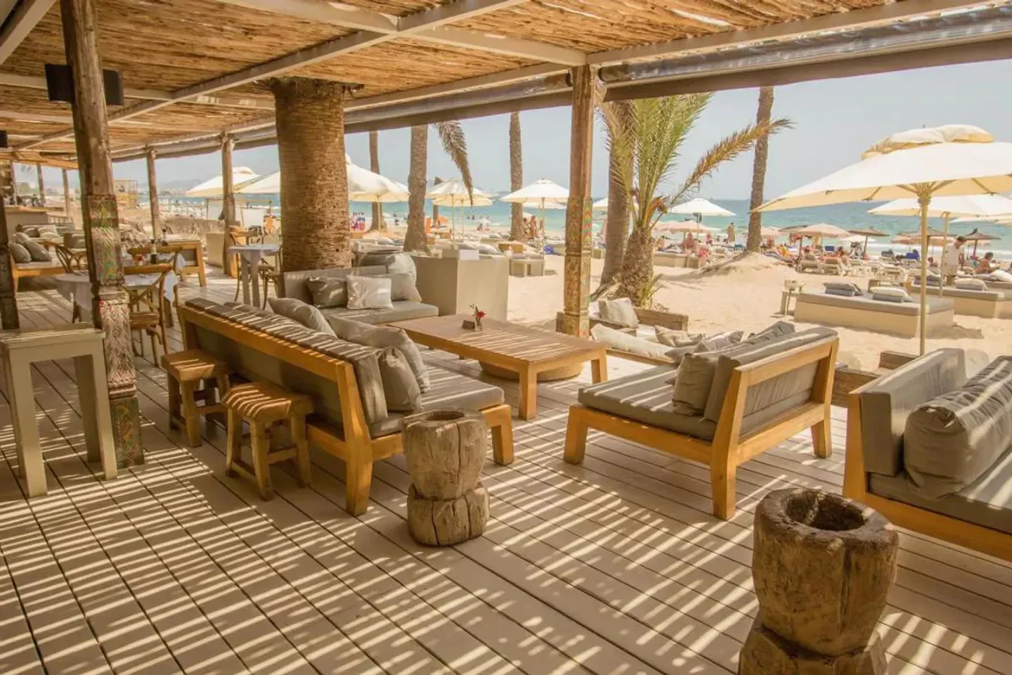 Beachouse Ibiza: wooden terrace seating with beach views and relaxing atmosphere