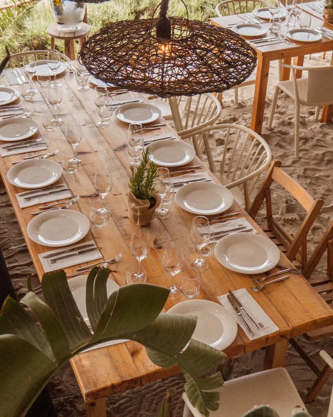 Table setting at Beso Beach Ibiza restaurant with beachside dining decor.