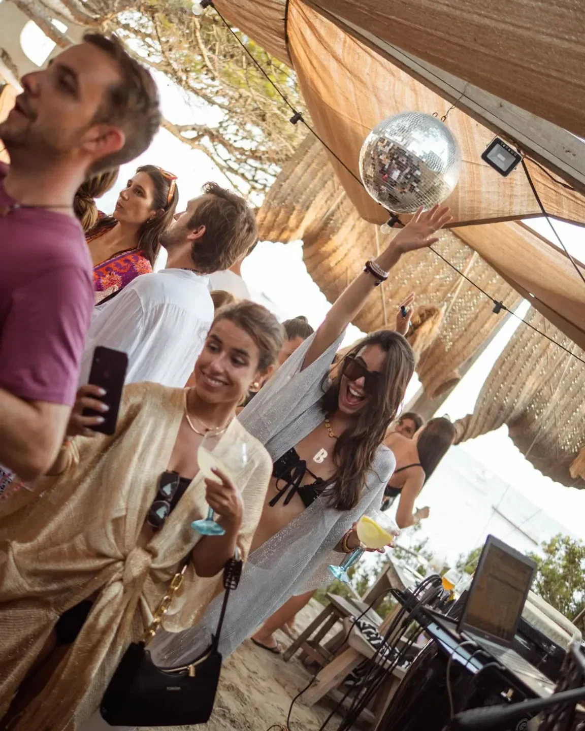 Party at Beso Beach Ibiza, dancing under a disco ball and celebrating summer.