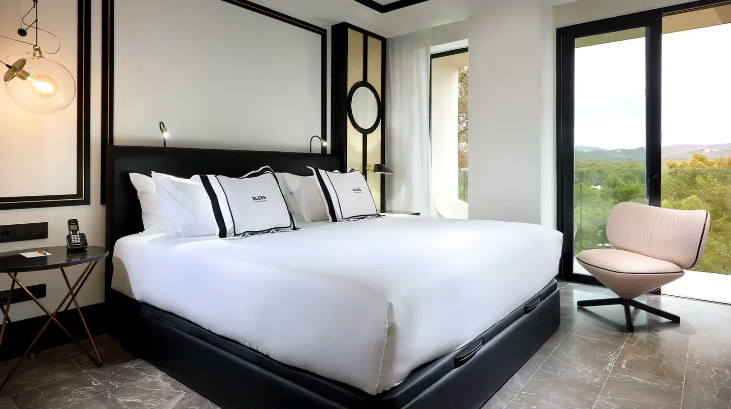 Modern bedroom at BLESS Hotel Ibiza with elegant decor and balcony views in Ibiza.