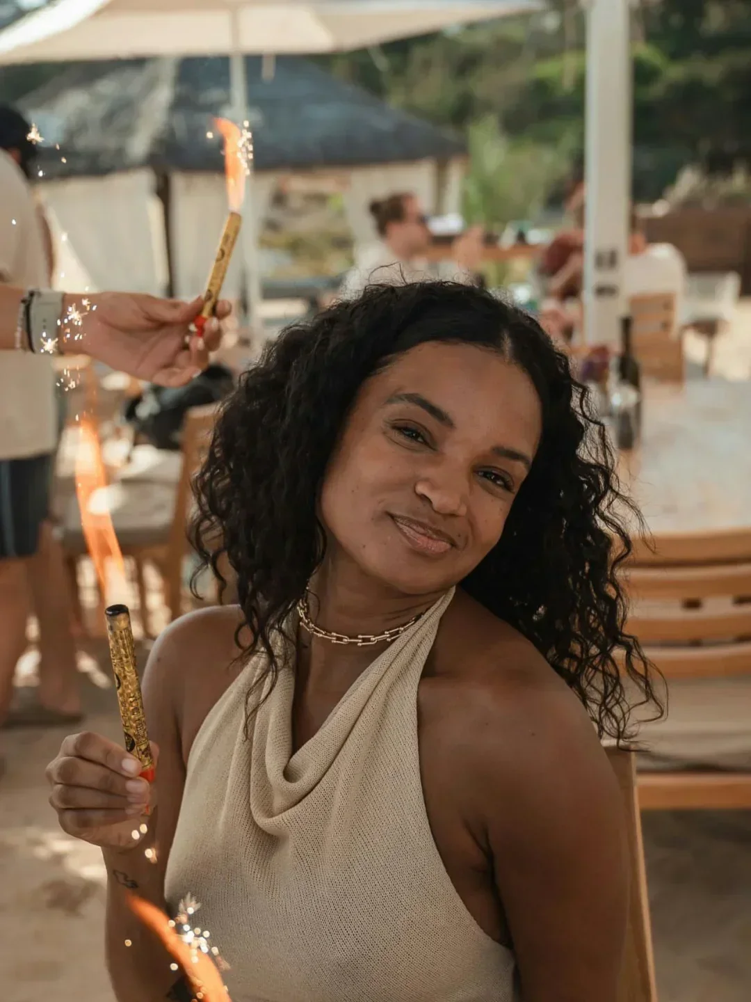 Smiling woman enjoying sparklers at Blue Marlin Ibiza restaurant