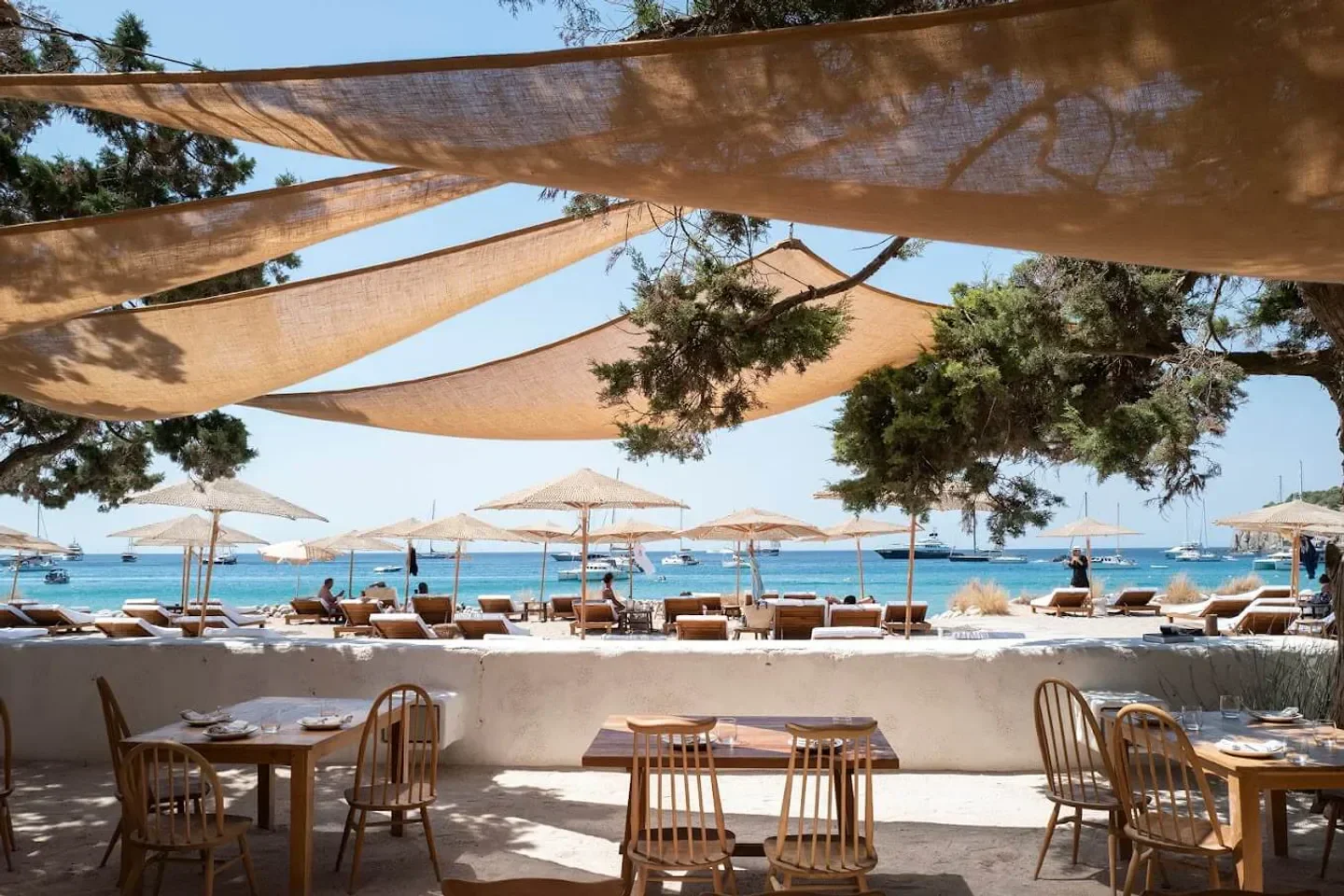Casa Jondal, Ibiza: Beachfront restaurant with tables and ocean views on a sunny day