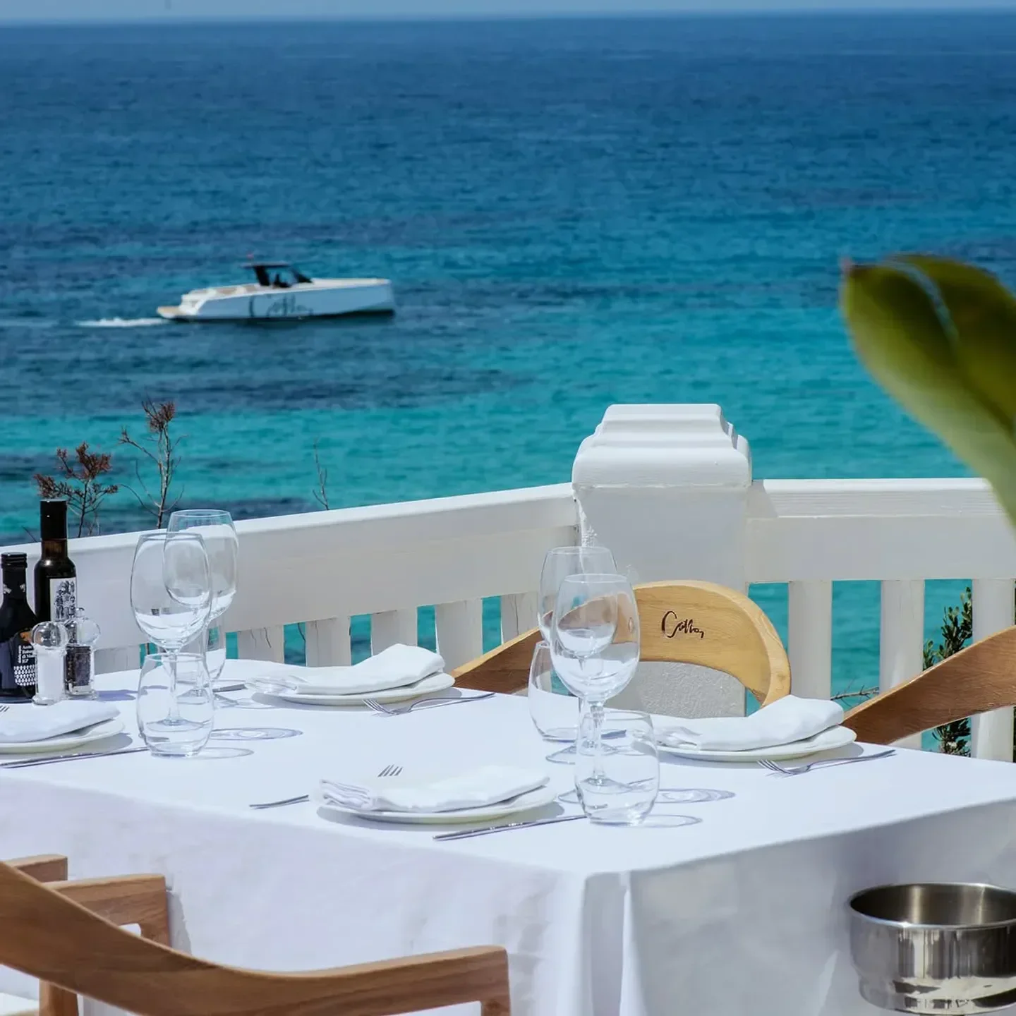 Table setting at Cotton Beach Club in Ibiza with ocean and boat view