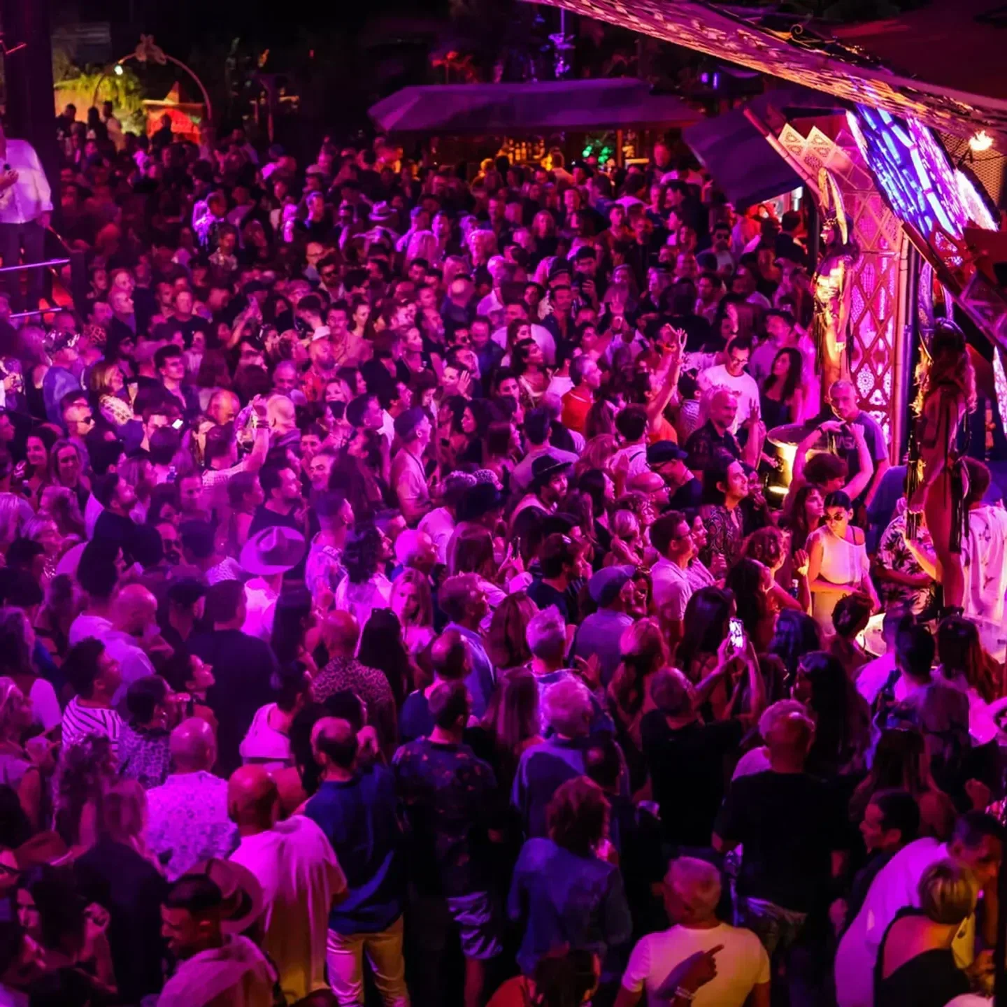 Energetic crowd at Cova Santa restaurant in Ibiza enjoying a vibrant night out.