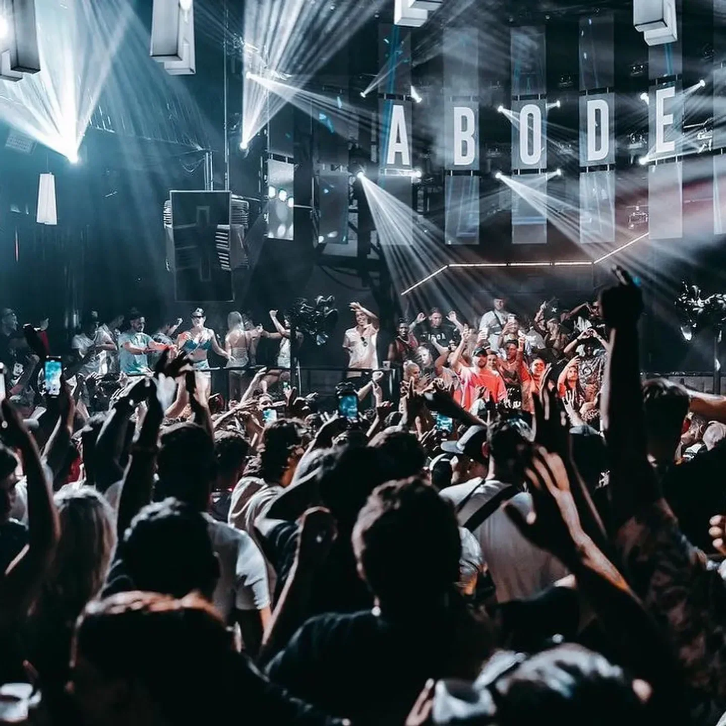 Energetic crowd at Eden Ibiza nightclub with bright lights and stage presence.