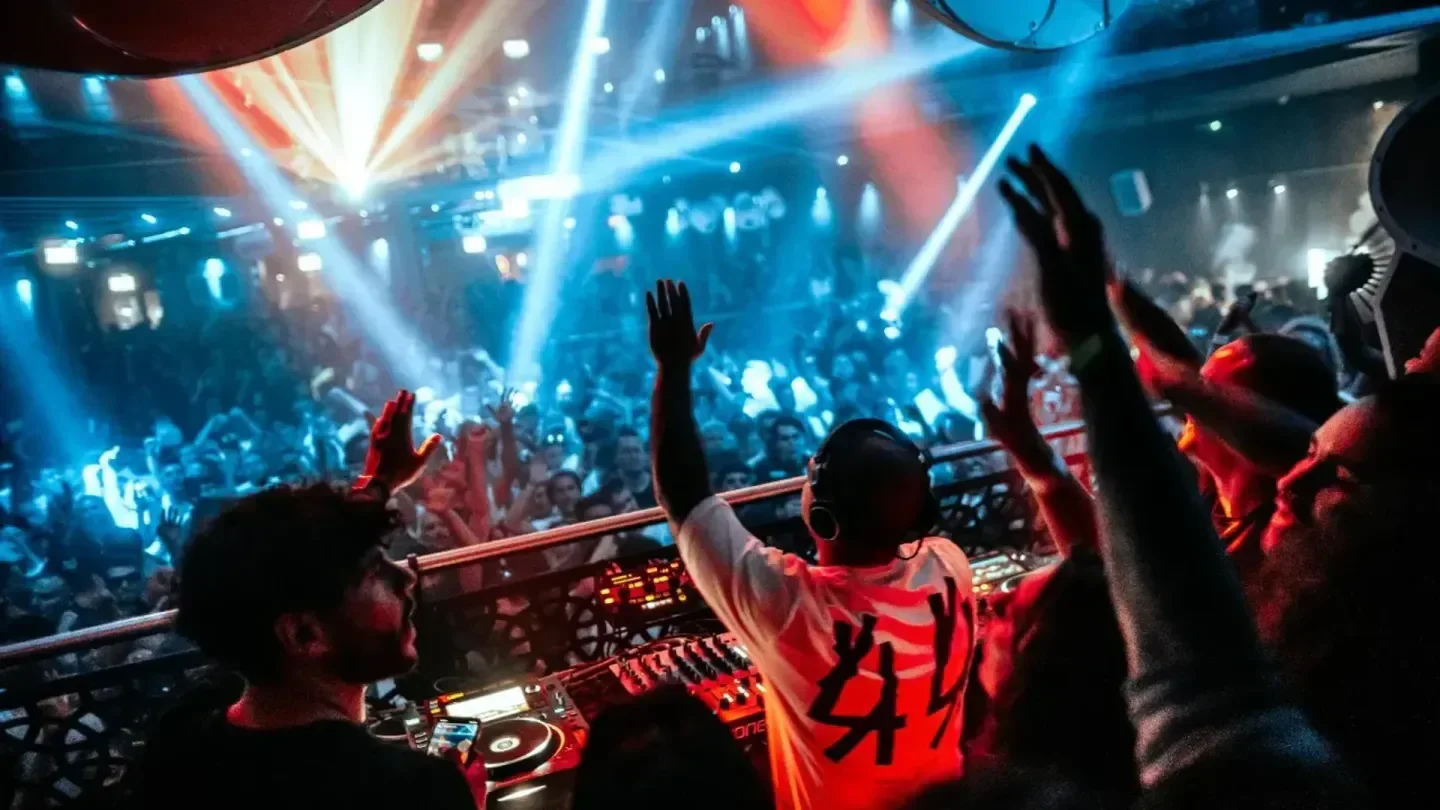 DJ and crowd enjoying the vibrant nightlife at Es Paradis nightclub in Ibiza.