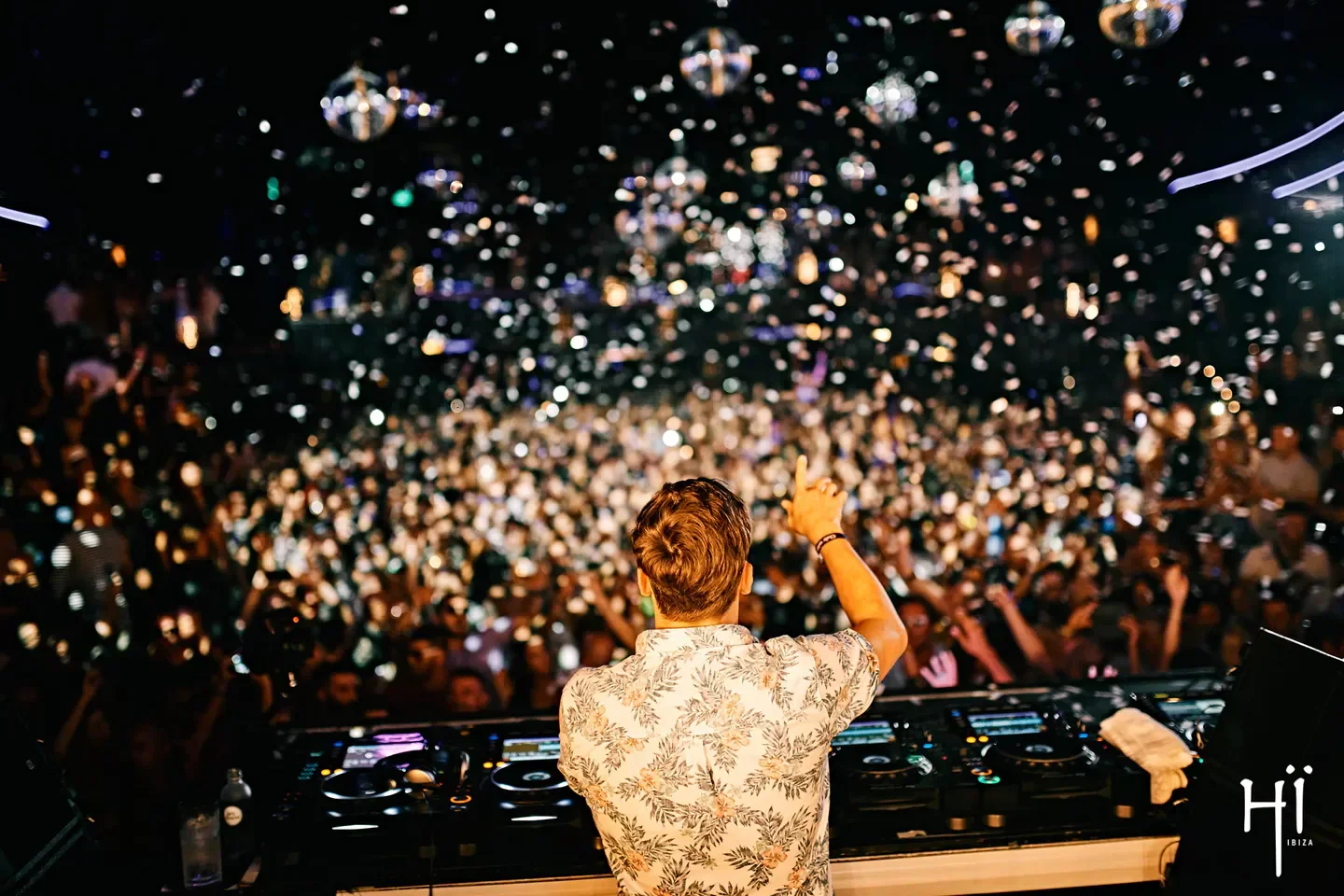 DJ at Hi Ibiza nightclub, with confetti and a lively crowd in Ibiza.