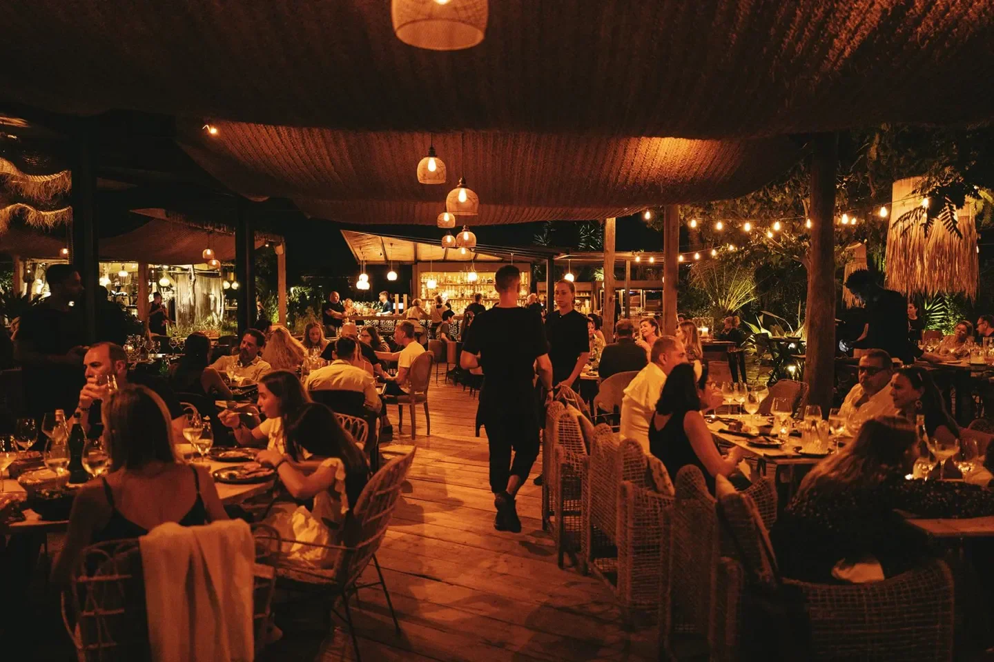 Jul's restaurant in Ibiza: diners enjoying a beautiful evening under the warm lights.