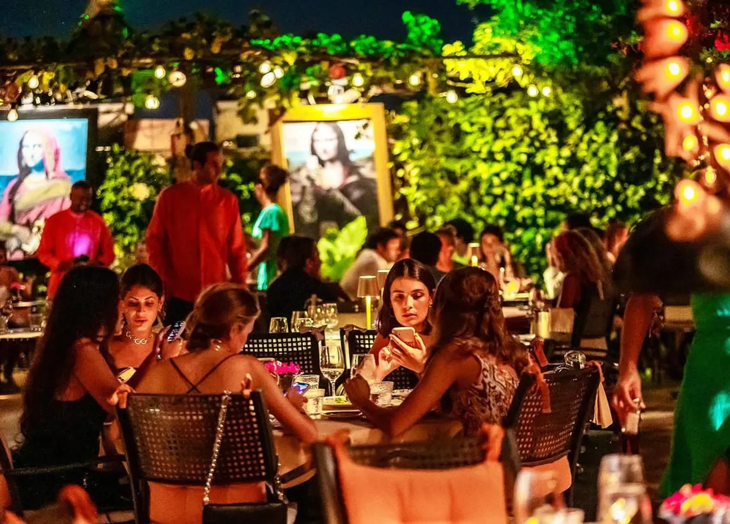 Dining at Las Dos Lunas Ibiza, a lively restaurant with outdoor seating and ambiance.