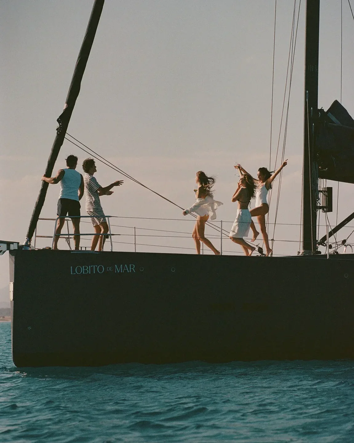Group of friends enjoying a boat trip on the sea with Lobito de Mar in Ibiza