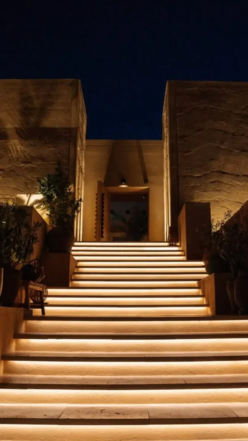 Madunia Ibiza restaurant exterior featuring a dramatic entrance with illuminated stairs and warm lighting at night
