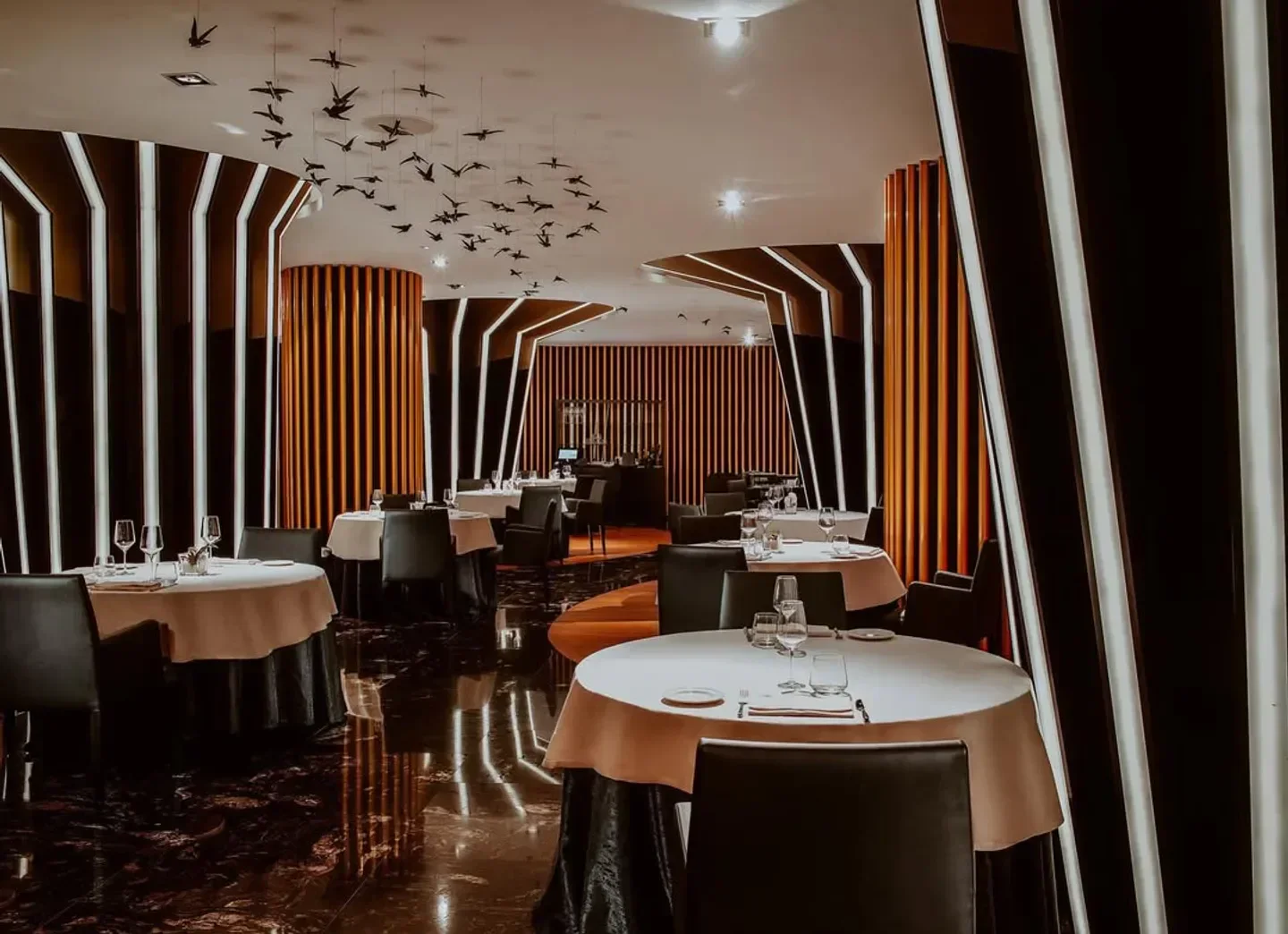 Elegant dining room at Montauk Steakhouse in Ibiza with artful decor.