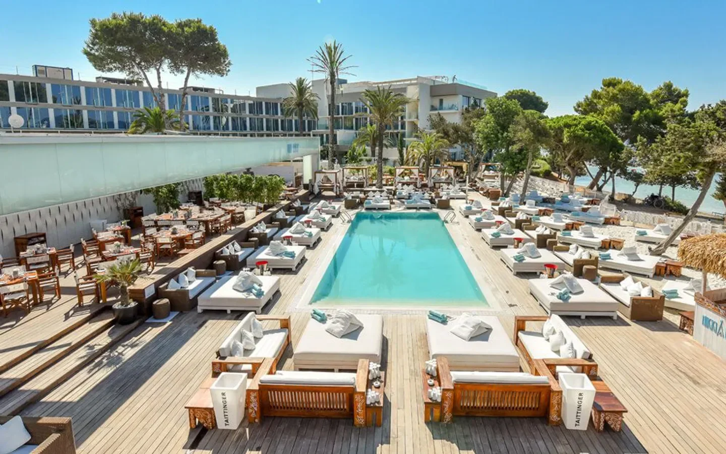 Nikki Beach Ibiza: luxurious pool area with sun loungers and ocean views.