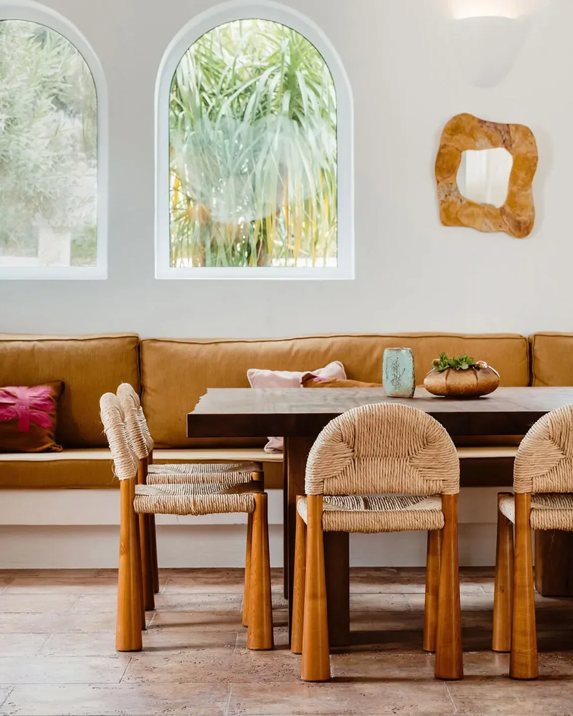 Dining room at Petunia restaurant in Ibiza with stylish woven chairs and natural light.