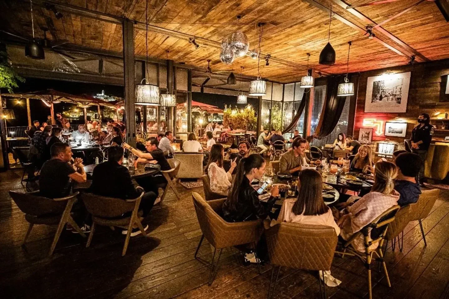 Dining scene at ROTO Ibiza restaurant, showing guests enjoying a night out.