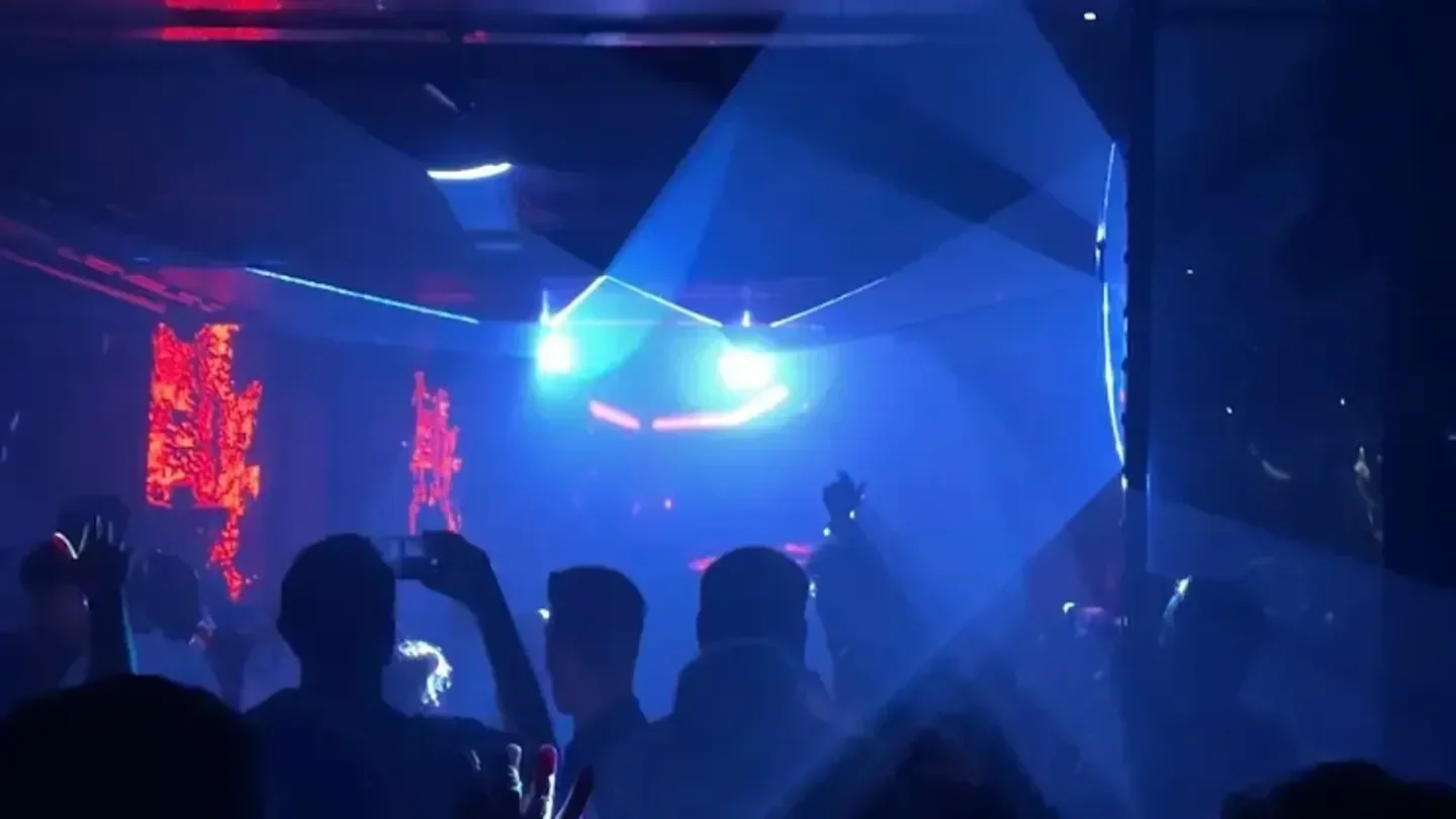 Energetic nightclub atmosphere at Tox Ibiza, vibrant lights and people enjoying the music