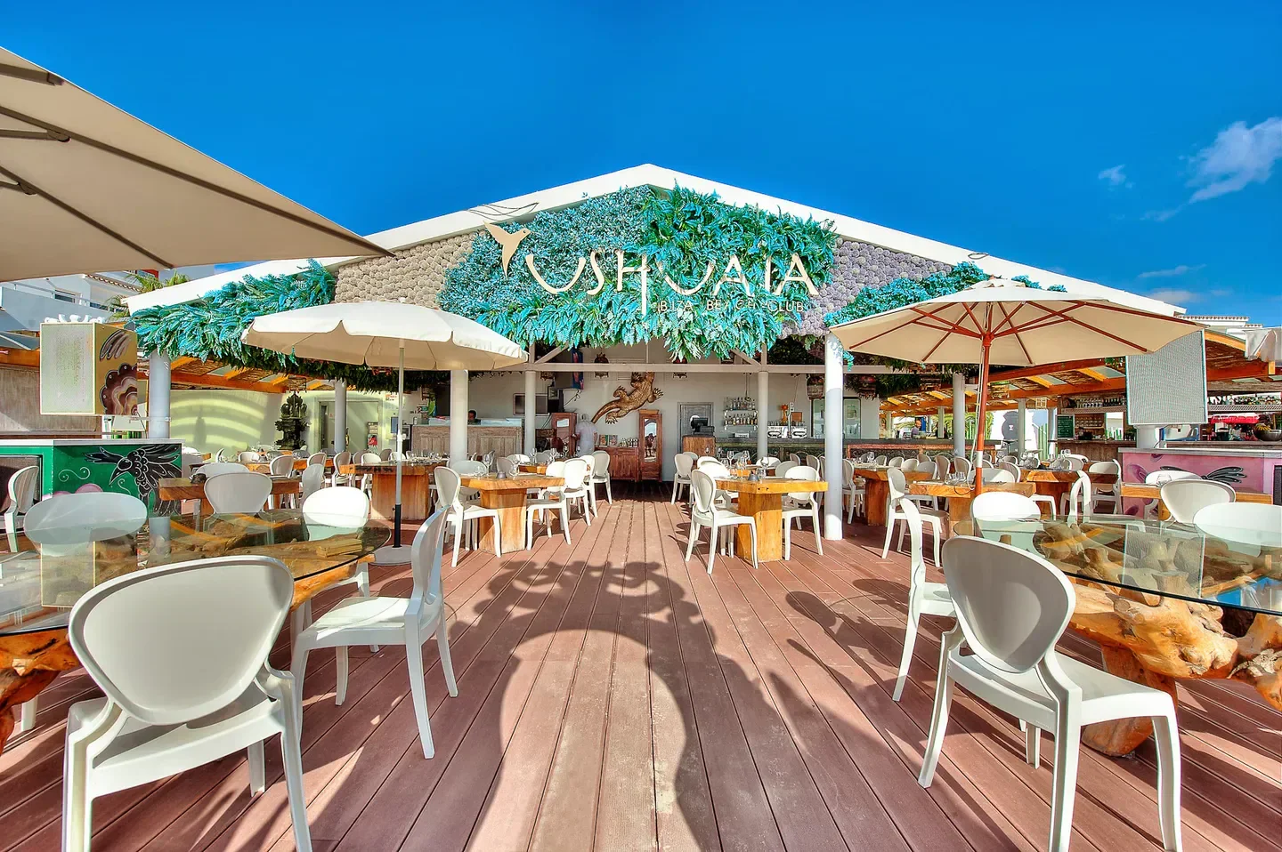 Outdoor dining at Ushuaïa Ibiza restaurant with umbrellas and stylish decor