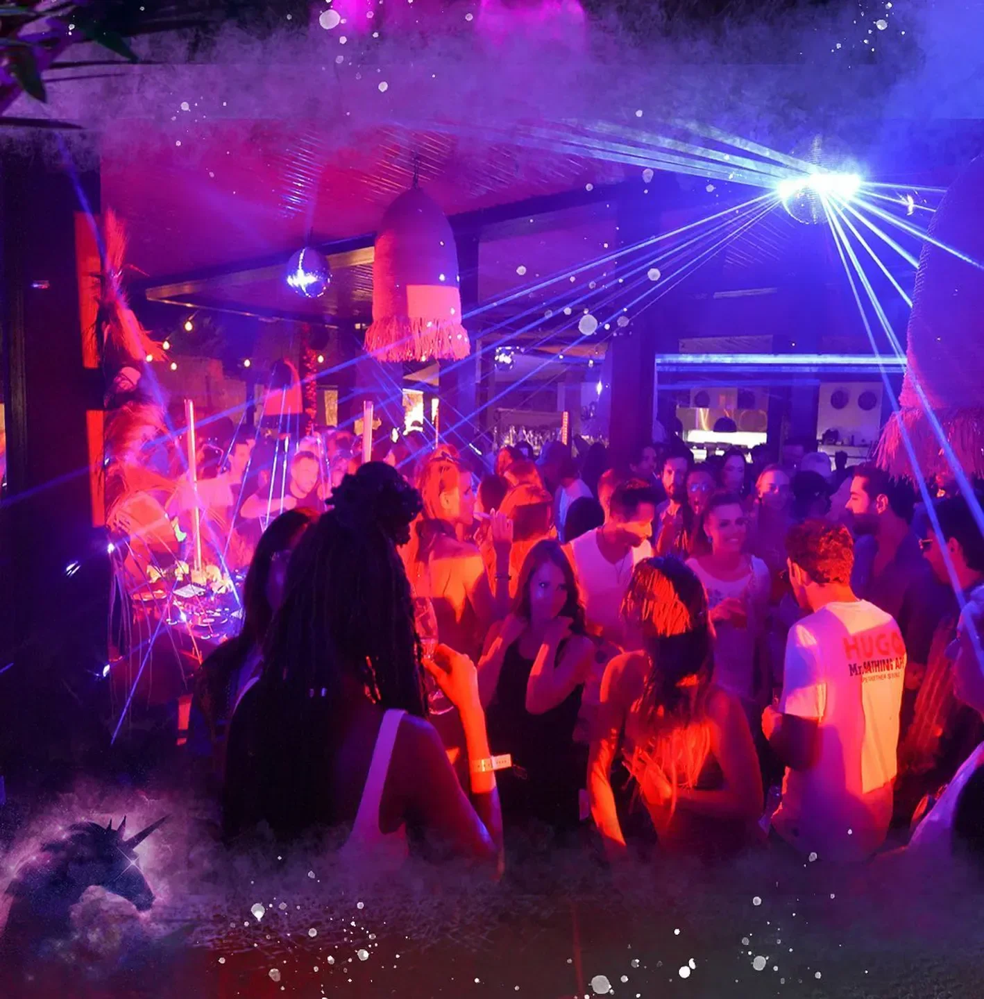 Energetic nightclub scene at Vybe in Ibiza, with lights and a crowd enjoying the party.